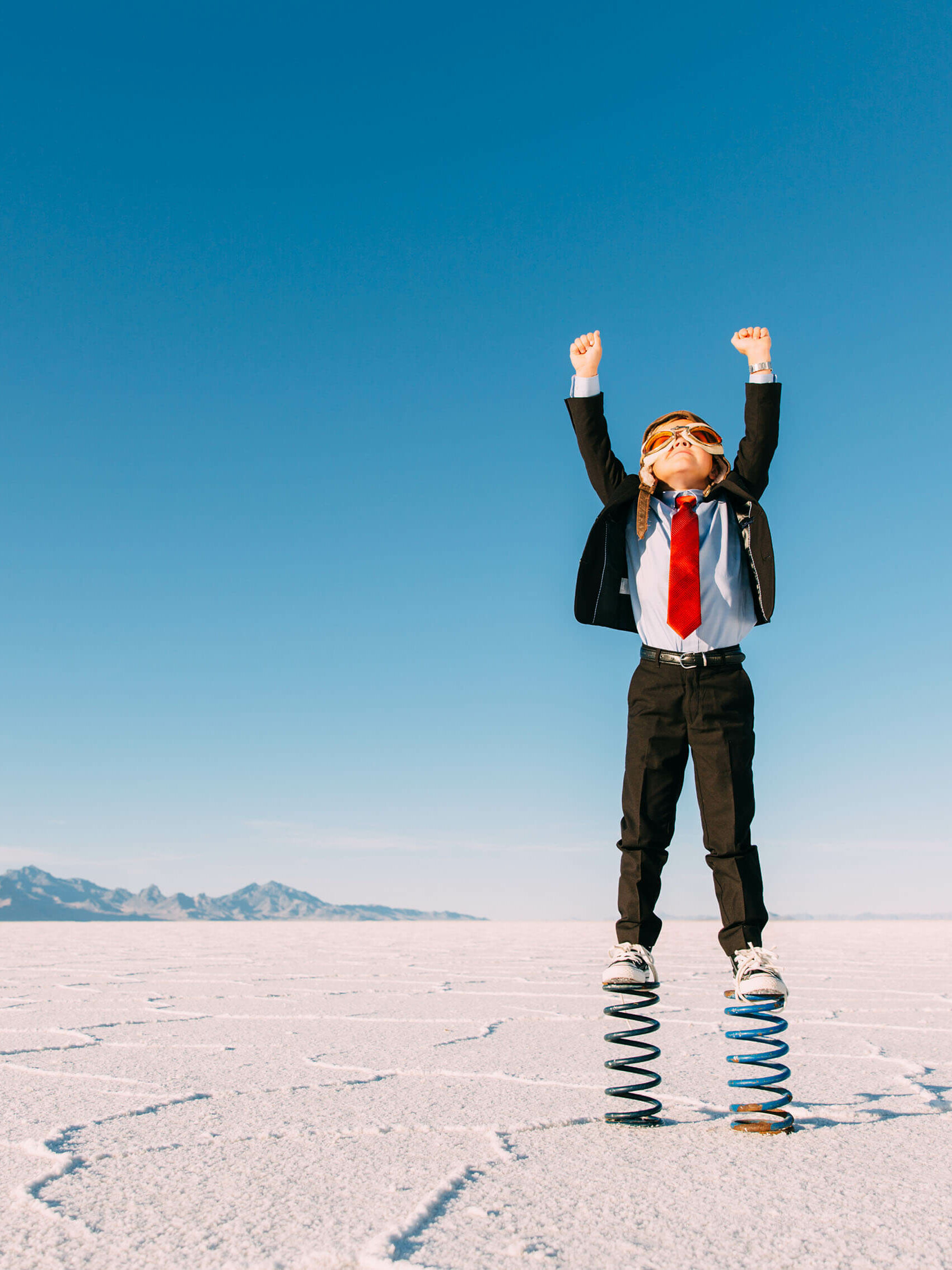 En liten pojke hoppar upp i luften.